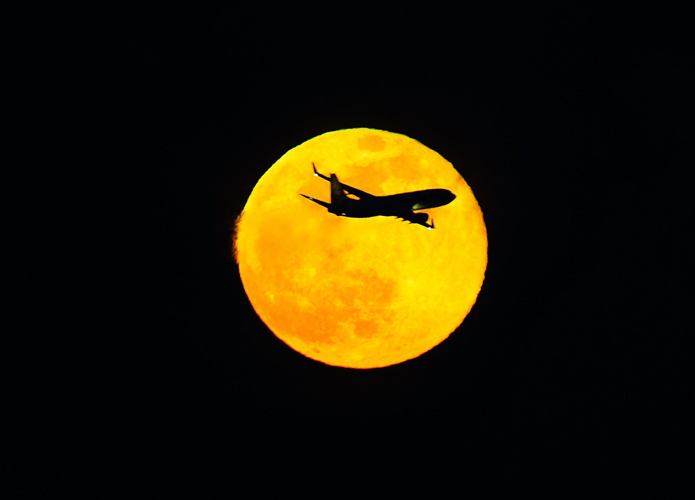 airplane in the full moon